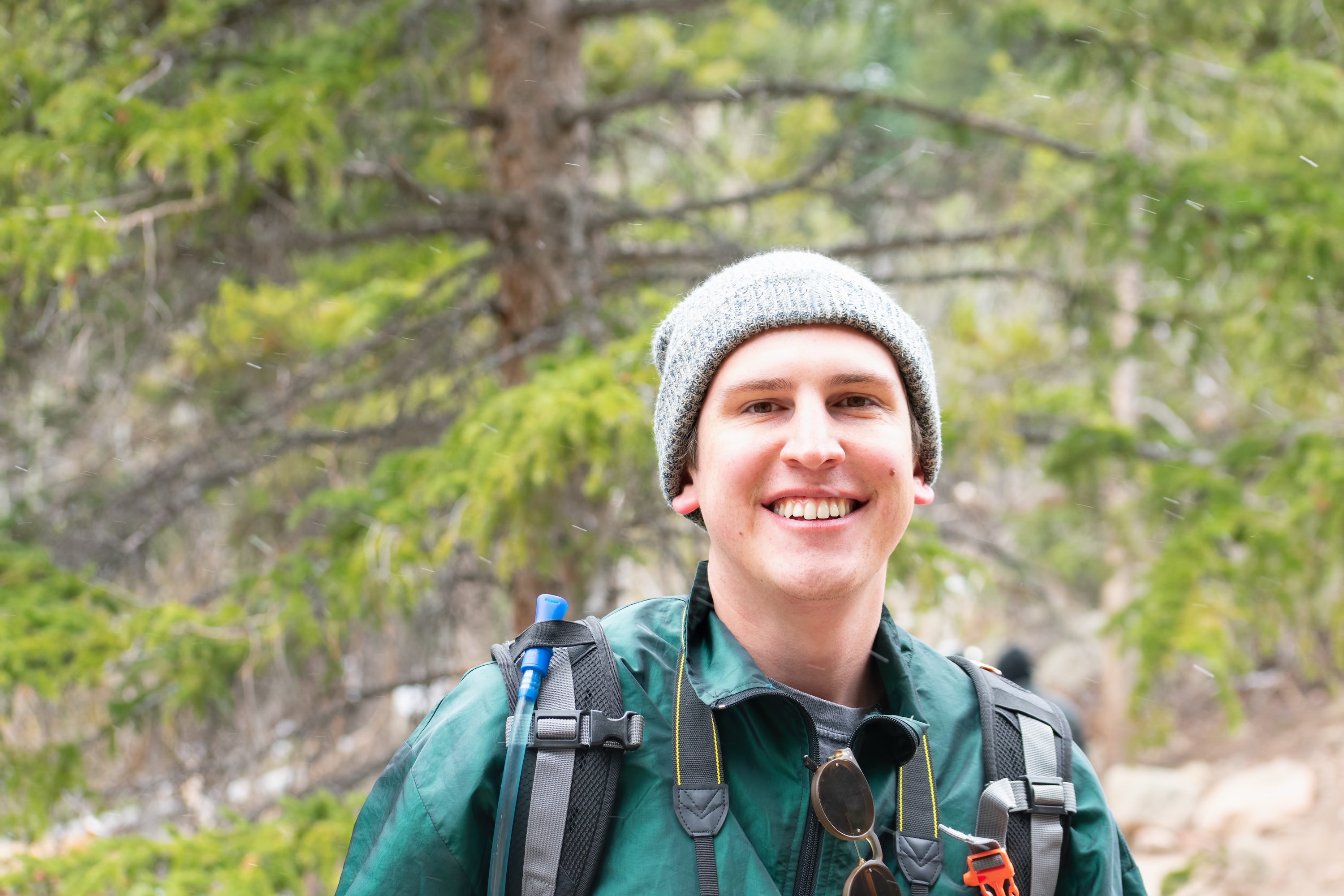Portrait of a smiling young man hiking in the mountains